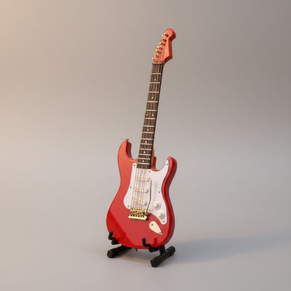 Regalos Ejecutivos Ortiz red electric guitar replica, 14cm, with white pickguard and gold hardware, displayed on a black stand.